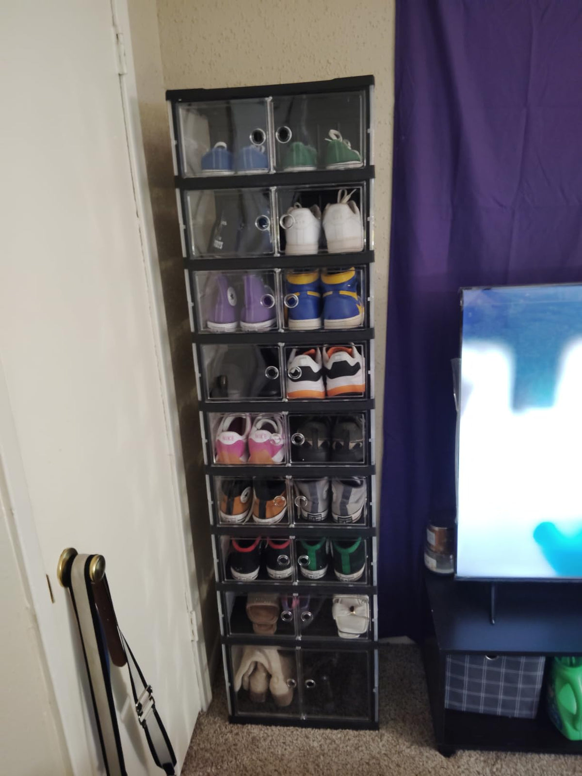 Hovrel six-cube shoe cabinet standing by a window with purple curtains, holding sneakers and sandals