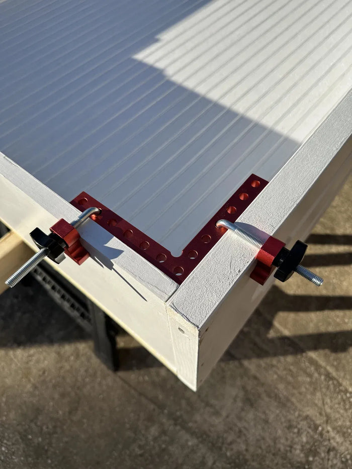 Customer photo - clamps holding a panel edge while glue dries